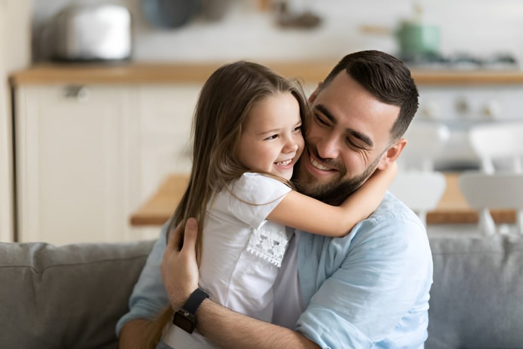 father hugging his daughter